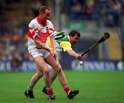 23 July 2000; Oliver Collins of Derry in action against Johnny Pilkington of Offaly during the Guinness All-Ireland Senior Hurling Championship Quarter-Final match between Offaly and Derry at Croke Park in Dublin. Photo by Ray Lohan/Sportsfile