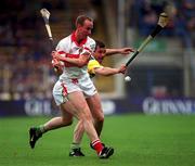 23 July 2000; Oliver Collins of Derry in action against Johnny Pilkington of Offaly during the Guinness All-Ireland Senior Hurling Championship Quarter-Final match between Offaly and Derry at Croke Park in Dublin. Photo by Ray Lohan/Sportsfile
