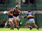23 July 2000; Joe Rabbitte of Galway gets his handpass away despite the attentions of John Carroll, 5, and David Kennedy of Tipperary during the Guinness All-Ireland Senior Hurling Championship Quarter-Final between Tipperary and Galway at Croke Park in Dublin. Photo by Brendan Moran/Sportsfile