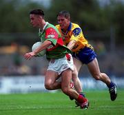30 July 2000; Conor Moran of Mayo is tackled by Paul Tiernan of Roscommon during the Connacht Minor Football Championship Final between Roscommon and Mayo at Dr Hyde Park in Roscommon. Photo by Ray Lohan/Sportsfile