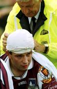 30 July 2000; Galway's Tommy Joyce receives attention to a head injury during the opening minutes of the Bank of Ireland Connacht Senior Football Championship Final between Galway and Leitrim at Dr Hyde Park in Roscommon. Photo by David Maher/Sportsfile
