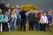 27 May 2015; Shane Warne, former Australian cricket player, plays his third shot from the rough on the 1st hole. Dubai Duty Free Irish Open Golf Championship 2015, Pro-Am. Royal County Down Golf Club, Co. Down. Picture credit: Oliver McVeigh / SPORTSFILE