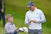 27 May 2015; Rory McIlroy signs an autograph for a young fan during his round. Dubai Duty Free Irish Open Golf Championship 2015, Pro-Am. Royal County Down Golf Club, Co. Down. Picture credit: Ramsey Cardy / SPORTSFILE