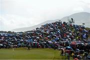29 May 2015; Large crowds at the 5th green take shelter from heavy rain. Dubai Duty Free Irish Open Golf Championship 2015, Day 2. Royal County Down Golf Club, Co. Down. Picture credit: Ramsey Cardy / SPORTSFILE