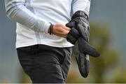 29 May 2015; Rory McIlroy puts on gloves during heavy rain. Dubai Duty Free Irish Open Golf Championship 2015, Day 2. Royal County Down Golf Club, Co. Down. Picture credit: Ramsey Cardy / SPORTSFILE