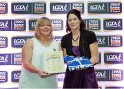 29 May 2015; Catherine Bennett, Offaly, right, is presented with her TESCO Team of the League award for Division 4 by Marie Hickey, LGFA President. TESCO Team of the League, Croke Park, Dublin. Picture credit: Piaras Ó Mídheach / SPORTSFILE