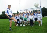 31 July 2008; The 9th annual MBNA Kick Fada competition was launched at Herbert Park, over 20 Inter-County Gaelic Football stars are set to compete for the prestigious All-Ireland title at the 2008 MBNA Kick Fada Final, which takes place on Saturday 13th at Bray Emmets GAA Club. Reigning champion John Brennan, from Carlow, will be back to defend his title after winning with a kick of 67 metres. At the launch is Dublin master free taker Tomas Quinn cheered on by children from Kilmacud Crokes GAA club, Raheny GAA club, Holy Trinity School, and Bray Emmets GAA. Herbert Park Hotel, Ballsbridge, Dublin Picture credit: Brian Lawless / SPORTSFILE