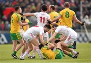 17 May 2015; Tyrone and Donegal players tussle during the game. Ulster GAA Football Senior Championship, Preliminary Round, Donegal v Tyrone. MacCumhaill Park, Ballybofey, Co. Donegal. Picture credit: Stephen McCarthy / SPORTSFILE
