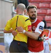 9 June 2015; St. Patrick's Athletic's Greg Bolger holds on to referee Padraig Sutton after a challenge. SSE Airtricity League Premier Division, St. Patrick's Athletic v Bohemians FC, Richmond Park, Dublin. Picture credit: David Maher / SPORTSFILE