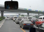 7 August 2008; Motorists wait for clearance to move during heavy traffic on a highway outside the city. The left lane is reserved for Games related traffic. Beijing 2008 - Games of the XXIX Olympiad, Beijing, China. Picture credit: Ray McManus / SPORTSFILE