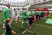 13 June 2015; Players from both teams take to the field accompanied by the match day mascots. UEFA EURO 2016 Championship Qualifier, Group D, Republic of Ireland v Scotland, Aviva Stadium, Lansdowne Road, Dublin. Picture credit: David Maher / SPORTSFILE