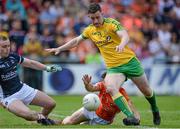 14 June 2015; Patrick McBrearty, Donegal, goes past James Morgan and Matthew McNiece, Armagh to score his sides first goal. Ulster GAA Football Senior Championship Quarter-Final, Armagh v Donegal. Athletic Grounds, Armagh. Picture credit: Oliver McVeigh / SPORTSFILE