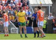 14 June 2015; Paddy McGrath, Donegal, and Jamie Clarke, Armagh, are both shown a yellow card by referee David Coldrick. Ulster GAA Football Senior Championship Quarter-Final, Armagh v Donegal. Athletic Grounds, Armagh. Picture credit: Brendan Moran / SPORTSFILE