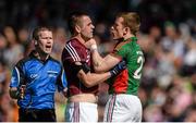 14 June 2015; Mayo's Donal Vaughan tangles with Galway's Patrick Sweeney as referee Padraig Hughes moves in. Connacht GAA Football Senior Championship Semi-Final, Galway v Mayo. Pearse Stadium, Galway. Picture credit: Piaras Ó Mídheach / SPORTSFILE