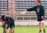 David Connolly splashes a bottle of water over Gary Breen during an Irish squad training session in the Steuea Stadium, Bucharest. 29/4/97. Soccer. Photograph: David Maher SPORTSFILE.