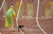21 August 2008; A member of BOCOG staff attempts to sweep the rain from the track before the start of the Women's 20km walk final. Beijing 2008 - Games of the XXIX Olympiad, National Stadium, Olympic Green, Beijing, China. Picture credit: Brendan Moran / SPORTSFILE
