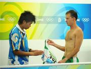 23 August 2008; Alistair Cragg, Ireland, hands his singlet to an official after the Men's 5000m Final, which he failed to finish. Beijing 2008 - Games of the XXIX Olympiad, National Stadium, Olympic Green, Beijing, China. Picture credit: Brendan Moran / SPORTSFILE