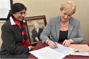 18 June 2015; Minister Heather Humphreys TD, Minister for Arts, Heritage and the Gaeltacht, signs a Fundraising Book of Remembrance in memory of the late Olivery Brady as Rita Shah, Co-Founder of Shabra Charity Foundation, holding a portrait of Brady, looks on, at the launch of the Shabra Charity Fundraising for the Genomic Sequencing Equipment for the Mater Hospital. Croke Park, Dublin. Picture credit: Cody Glenn / SPORTSFILE