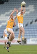 20 June 2015; Tony Scullion, Antrim, supported by team-mate Michael Pollock, gathers possession ahead of Stephen Attride, Laois. GAA Football All-Ireland Senior Championship, Round 1A, Laois v Antrim, O'Moore Park, Portlaoise, Co. Laois. Picture credit: Piaras Ó Mídheach / SPORTSFILE