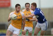 20 June 2015; Antrim's Jack Dowling, supported by team-mate Niall Delargy, in action against Evan O'Carroll, Laois. GAA Football All-Ireland Senior Championship, Round 1A, Laois v Antrim, O'Moore Park, Portlaoise, Co. Laois. Picture credit: Piaras Ó Mídheach / SPORTSFILE