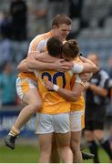 20 June 2015; Antrim's Owen Gallagher, left, celebrates with team-mates Patrick McBride, centre, and Mark Sweeney, after the game. GAA Football All-Ireland Senior Championship, Round 1A, Laois v Antrim, O'Moore Park, Portlaoise, Co. Laois. Picture credit: Piaras Ó Mídheach / SPORTSFILE
