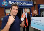 29 August 2008; Olympic boxing silver medalist Kenny Egan, left, with Leon Blanche from Boylesports, centre, and Gerard Flemming, Kenny's coach in Neilstown Boxing Club, at the Boylesports shop in Neilstown. Kenny collected his winnings after he placed a bet on himself to win a medal in Beijing. Boylesports generously trebled his winnings and gave the same amount to Kenny’s club in Neilstown to prepare the boxers of the future. Boylseports, Clondalkin, Dublin. Picture credit: Brian Lawless / SPORTSFILE