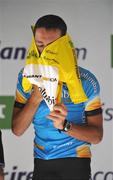 31 August 2008; Marco Pinotti, Team Columbia, pulls on the race winners yellow jersey after winning the 2008 Tour of Ireland. 2008 Tour of Ireland - Stage 5, Killarney - Cork. Picture credit: Stephen McCarthy / SPORTSFILE