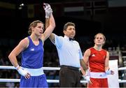 24 June 2015; Katie Taylor, Ireland, is announced victorious over Ida Lundblad, Sweden, by referee Jones Kennedy Silva do Rosario, following their Women's Boxing Light 60kg Quarter Final bout. 2015 European Games, Crystal Hall, Baku, Azerbaijan Picture credit: Stephen McCarthy / SPORTSFILE