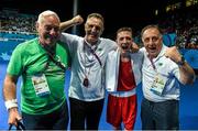 24 June 2015; Brendan Irvine, Ireland, celebrates his victoryover Dmytro Zamotayev, Ukraine, with coaches, from left, Gerry Storey, Billy Walsh and Zaur Antia following his Men's Boxing Light Fly 49kg Semi Final bout. 2015 European Games, Crystal Hall, Baku, Azerbaijan. Picture credit: Stephen McCarthy / SPORTSFILE