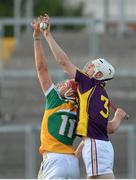 24 June 2015; Liam Ryan, Wexford, in action against Johnny O'Toole Greene, Offaly. Bord Gáis Energy Leinster GAA Hurling U21 Championship, Semi-Final, Offaly v Wexford. O'Connor Park, Tullamore, Co. Offaly. Picture credit: Piaras Ó Mídheach / SPORTSFILE