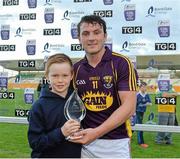 24 June 2015; Ten year old Darragh Kirwan, from Wexford Town, presents the man of the match award to Wexford's Kevin Foley. Bord Gáis Energy Leinster GAA Hurling U21 Championship, Semi-Final, Offaly v Wexford, O'Connor Park, Tullamore, Co. Offaly. Picture credit: Matt Browne / SPORTSFILE