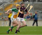 24 June 2015; Peter Sutton, Wexford, in action against Darragh Corbett, Offaly. Bord Gáis Energy Leinster GAA Hurling U21 Championship, Semi-Final, Offaly v Wexford. O'Connor Park, Tullamore, Co. Offaly. Picture credit: Piaras Ó Mídheach / SPORTSFILE