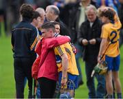 25 June 2015; Clare's Colm Fitzgerald is comforted by his mother Ciara Flynn after the game. 2015 Electric Ireland Munster GAA Hurling Minor Championship, Clare v Tipperary. Semple Stadium, Thurles, Co. Tipperary. Picture credit: Ray McManus / SPORTSFILE