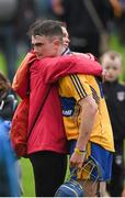 25 June 2015; Clare's Colm Fitzgerald is comforted by his mother Ciara Flynn after the game. 2015 Electric Ireland Munster GAA Hurling Minor Championship, Clare v Tipperary. Semple Stadium, Thurles, Co. Tipperary. Picture credit: Ray McManus / SPORTSFILE