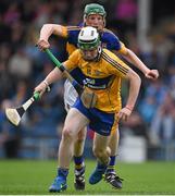 25 June 2015; Conor O'Halloran, Clare, in action against Brian McGrath, Tipperary. 2015 Electric Ireland Munster GAA Hurling Minor Championship, Clare v Tipperary. Semple Stadium, Thurles, Co. Tipperary. Picture credit: Ray McManus / SPORTSFILE