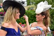 27 June 2015; Galway friends Sabrina Murphy, left, and Colleen Brady tweak their hats. Curragh Derby Festival. The Curragh, Co. Kildare. Picture credit: Cody Glenn / SPORTSFILE