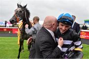 27 June 2015; Jockey Chris Hayes is hugged by owner David Nicholls after Hayes rode his horse Sovereign Debt to a win in The Dubai Duty Free Full of Surprises Celebration Stakes. Curragh Derby Festival. The Curragh, Co. Kildare. Picture credit: Cody Glenn / SPORTSFILE