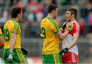 27 June 2015; Martin McElhinney, Donegal, grapples with Ciaran McFaul, Derry after a high changles near the end which he received a black card. Ulster GAA Football Senior Championship, Semi-Final, Derry v Donegal. St Tiernach's Park, Clones, Co. Monaghan. Picture credit: Oliver McVeigh / SPORTSFILE
