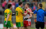 27 June 2015; Martin McElhinney, Donegal, grapples with Ciaran McFaul, Derry, after a high challenge near the end, for which he received a black card. Ulster GAA Football Senior Championship, Semi-Final, Derry v Donegal. St Tiernach's Park, Clones, Co. Monaghan. Picture credit: Oliver McVeigh / SPORTSFILE