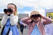 28 June 2015; Sisters Annabel, age 5, and Clara, age 3, Keating get a view through binoculars. Curragh Derby Festival. The Curragh, Co. Kildare. Picture credit: Cody Glenn / SPORTSFILE