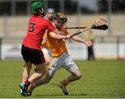 28 June 2015; Diarmaid McShane, Antrim, in action against Ciaran Monan, Down. Electric Ireland Ulster GAA Hurling Minor Championship, Semi-Final, Derry v Down. Owenbeg, Derry. Picture credit: Seb Daly / SPORTSFILE