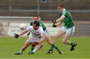 28 June 2015; Aidan McCrory, Tyrone, in action against Brian Fanning and Peter Nash, Limerick. GAA Football All-Ireland Senior Championship, Round 1B, Tyrone v Limerick. Healy Park, Omagh, Co. Tyrone. Picture credit: Oliver McVeigh / SPORTSFILE