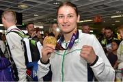 29 June 2015; Katie Taylor, Team Ireland, holds up her gold medal on her return from the 2015 Baku European Games. Terminal One, Dublin Airport.  Picture credit: Cody Glenn / SPORTSFILE