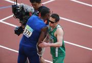 15 September 2008; Ireland's Jason Smyth, from Eglington, Co. Derry, is congratulated by Cuba's Luis Manuel Galano after the Men's 200m -T13 heats. Smyth who already bagged gold for the Men's 100m T13 Final setting a world record of 10.62 again set a new world record time of 21.81 sec taking .02 of a second off his own record set in Holland in 2006. The final of the Men's 200m will take place tomorrow Tuesday 16th. Beijing Paralympic Games 2008, Men's 200m -T13, Heat 1, National Stadium, Olympic Green, Beijing, China. Picture credit: Brian Lawless / SPORTSFILE