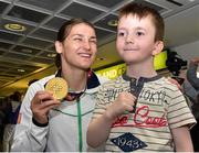 29 June 2015; Katie Taylor, Team Ireland, is greeted by future boxer Adam Hardyman, 6, of Dublin, on her return from the 2015 Baku European Games. Terminal One, Dublin Airport.  Picture credit: Cody Glenn / SPORTSFILE