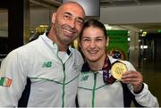 29 June 2015; Katie Taylor, Team Ireland, with her father and coach Pete Taylor on their return from the 2015 Baku European Games. Terminal One, Dublin Airport.  Picture credit: Cody Glenn / SPORTSFILE