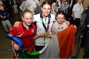 29 June 2015; Katie Taylor, Women's Boxing Light 60kg gold, Team Ireland, is greeted by fans Sophie Clancy, 12, left, and Ellie Maher, 10, from St. Josephs Boxing Club, Edenderry, on her return from the 2015 Baku European Games. Terminal One, Dublin Airport. Picture credit: Cody Glenn / SPORTSFILE