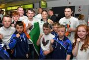 29 June 2015; Katie Taylor, Women's Boxing Light 60kg gold, Team Ireland, is greeted by boxing fans from St. Pauls Boxing Club, Belfast, on her return from the 2015 Baku European Games. Terminal One, Dublin Airport. Picture credit: Cody Glenn / SPORTSFILE