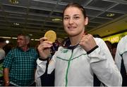 29 June 2015; Katie Taylor, Women's Boxing Light 60kg gold, Team Ireland, holds up the gold on her return from the 2015 Baku European Games. Terminal One, Dublin Airport. Picture credit: Cody Glenn / SPORTSFILE