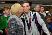 29 June 2015; Brendan Irvine, Men's Boxing Light Fly 49kg silver, Team Ireland, is kissed by his mother Brenda from Belfast on his return from the 2015 Baku European Games. Terminal One, Dublin Airport. Picture credit: Cody Glenn / SPORTSFILE